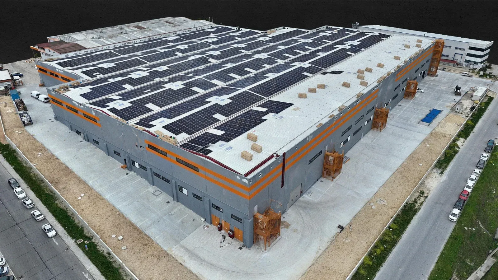 Drone-generated 3D model of a factory site with solar panels on the roof